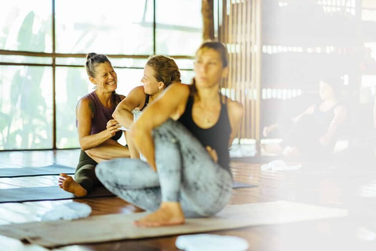 Guests relaxing together on the yoga shala floor at Orion Healing Centre, Koh Phangan